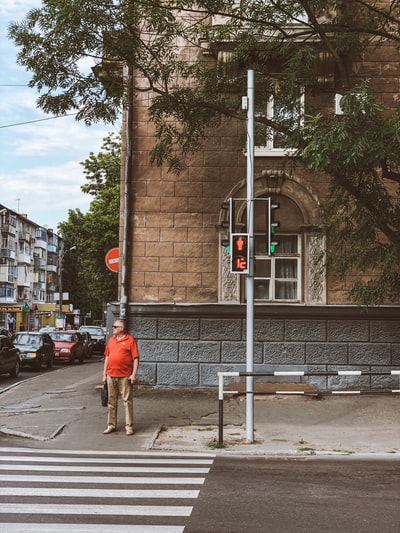 Man standing on the sidewalk near the sidewalk
